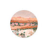 Round art coasters of an arid landscape from Kitchen & Tabletop, featuring muted pink, brown, and green tones.