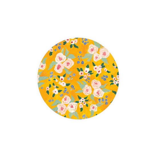 Floral patterned coasters by Margaret Teak, on a golden yellow backdrop.