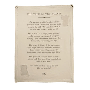 Canvas wall hanging with "Tale of Two Wolves" text, from an unknown source, featuring distressed edges and metal grommets.
