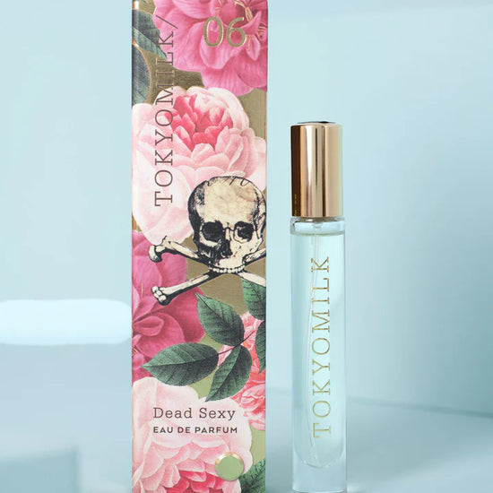 Fragrance travel spray by TokyoMilk with skull and crossbones over a rose floral design.
