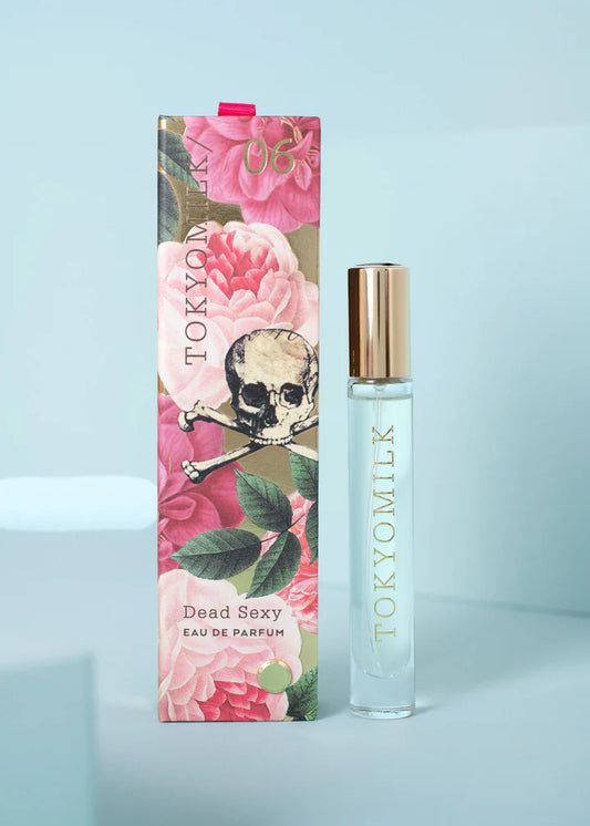 Fragrance travel spray by TokyoMilk with skull and crossbones over a rose floral design.