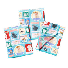 Set of three mini towels by Blue Q, featuring a colorful, reversible, cat and postage stamp pattern.