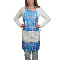 Blue patterned apron from Super Blue featuring a front pocket and kitchen utensil graphics.
