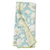 Reversible towel with floral pattern by Studio Oh! featuring a blue background with white flowers and green trim.